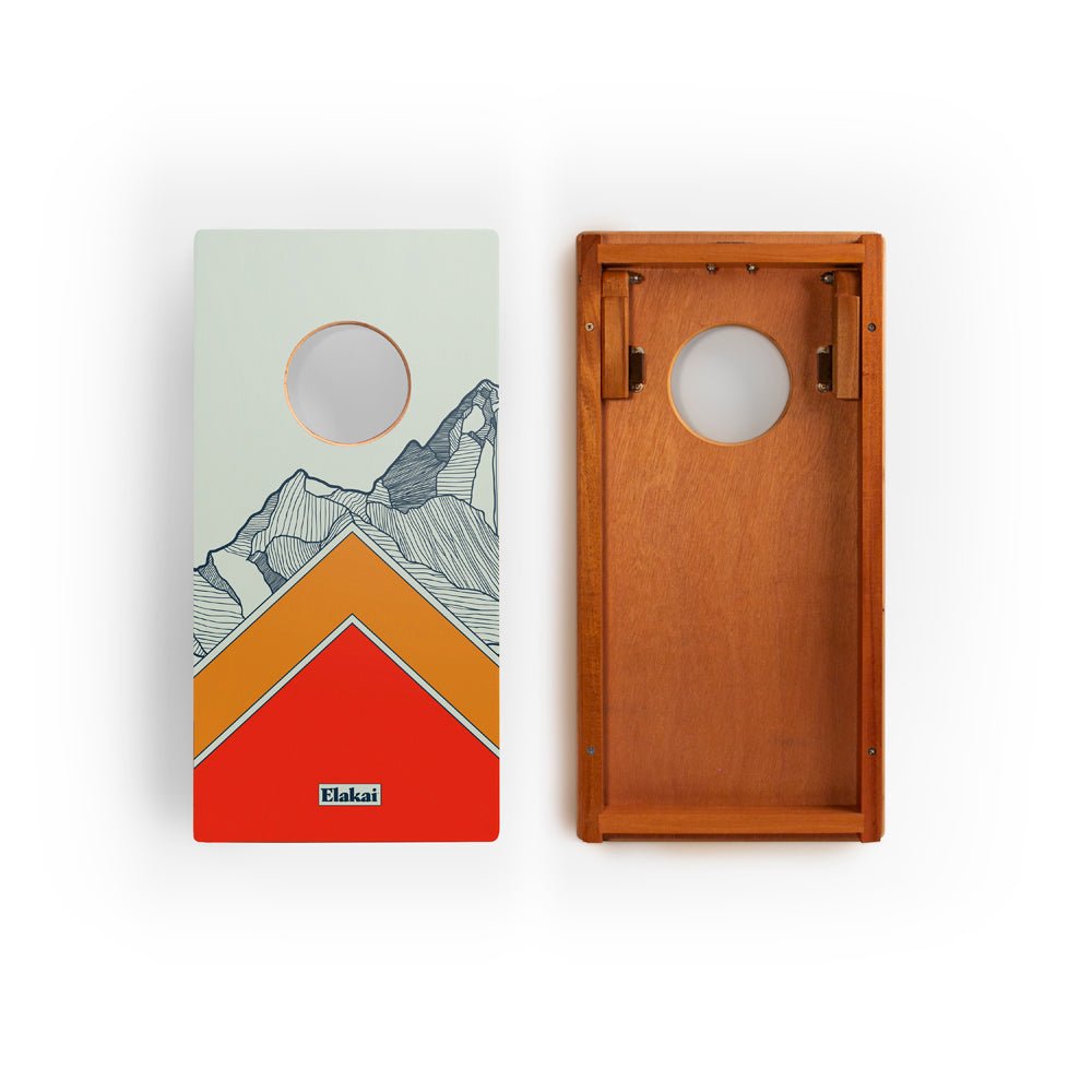 Two cornhole boards with mountain design and wooden texture on a white background
