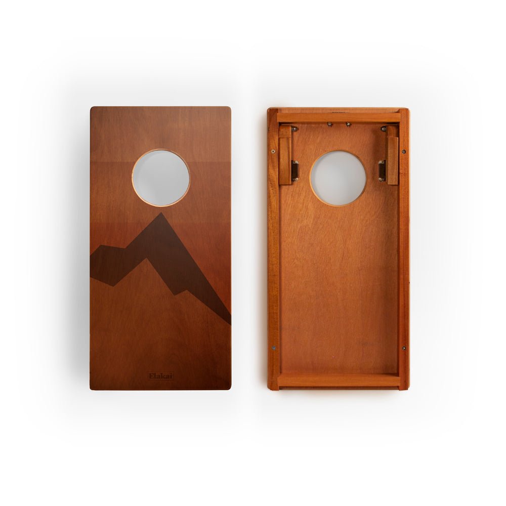Two wooden boards with mountain and moon designs on a white background