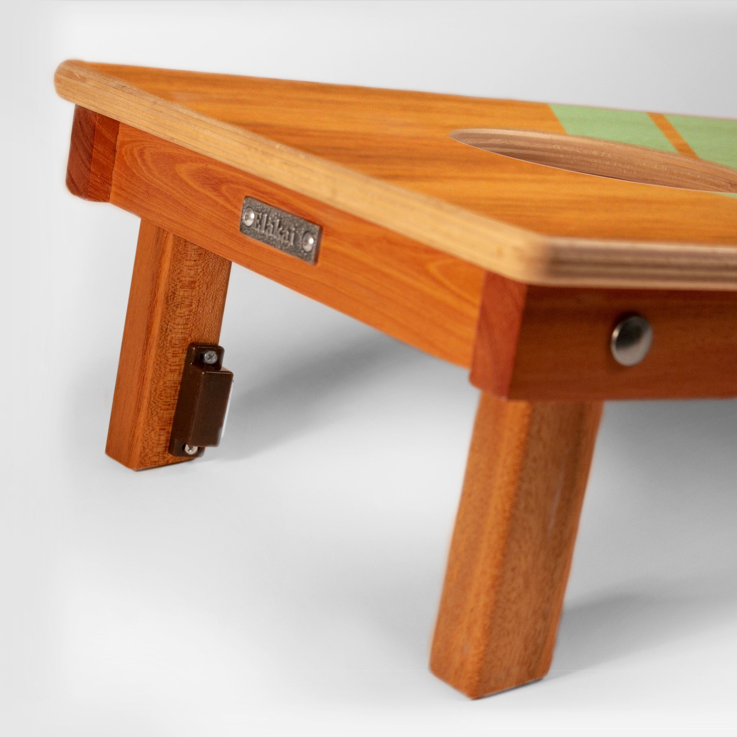 Wooden step stool with a metal plate on a white background