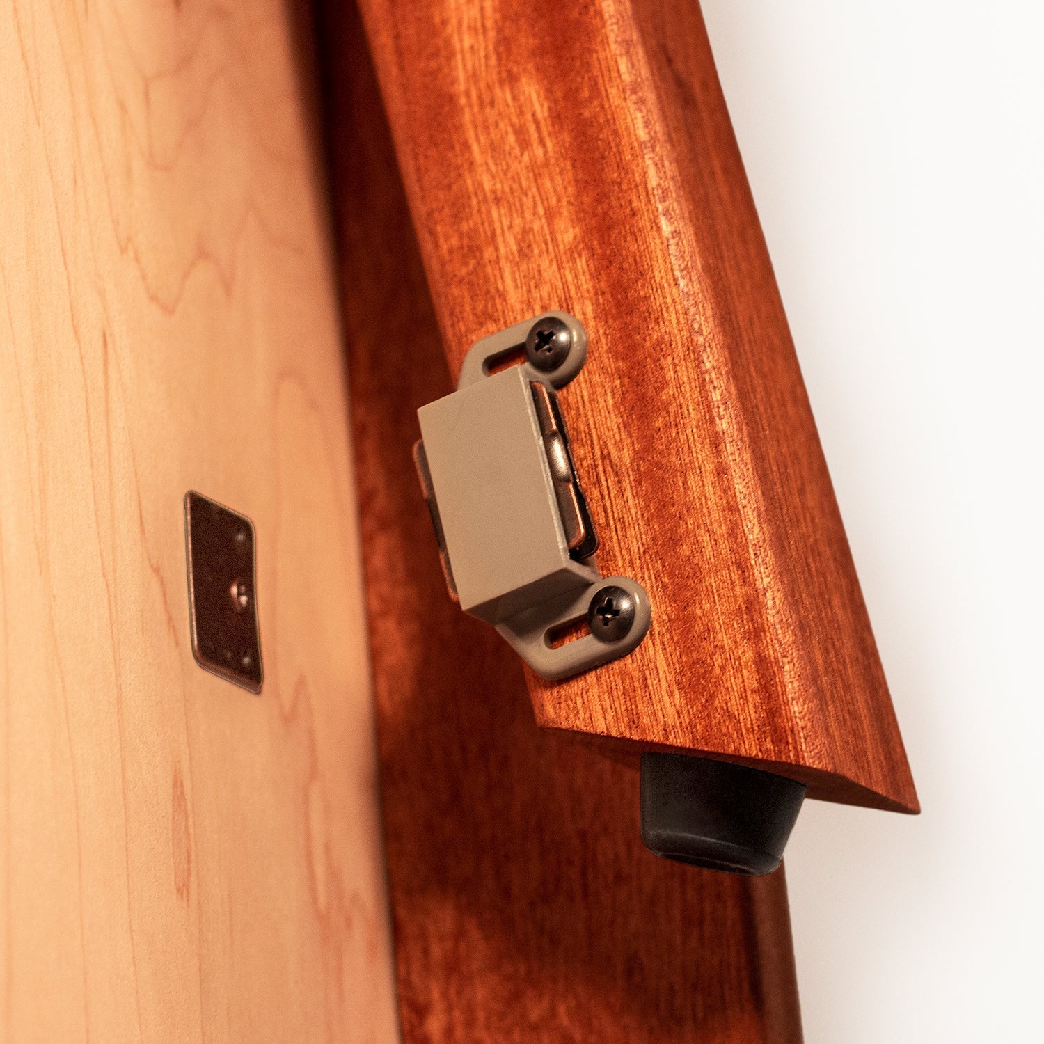 Close-up of a guitar's bridge and part of its body with a wooden finish.