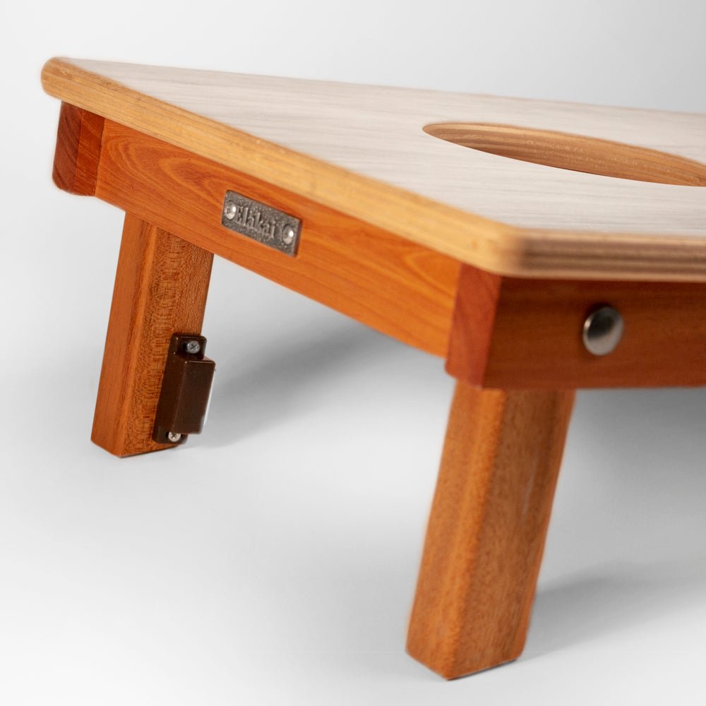 Wooden bench with a white cushion on a light gray background