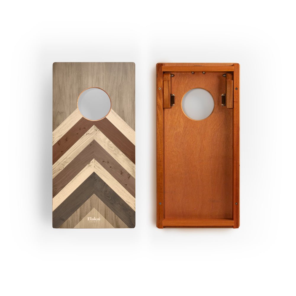 Two wooden cornhole boards with a chevron pattern on a white background