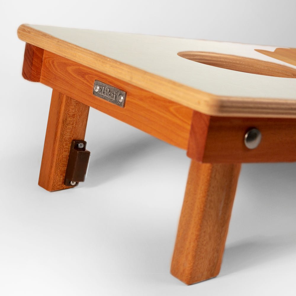 Wooden bench with a white cushion on a light gray background