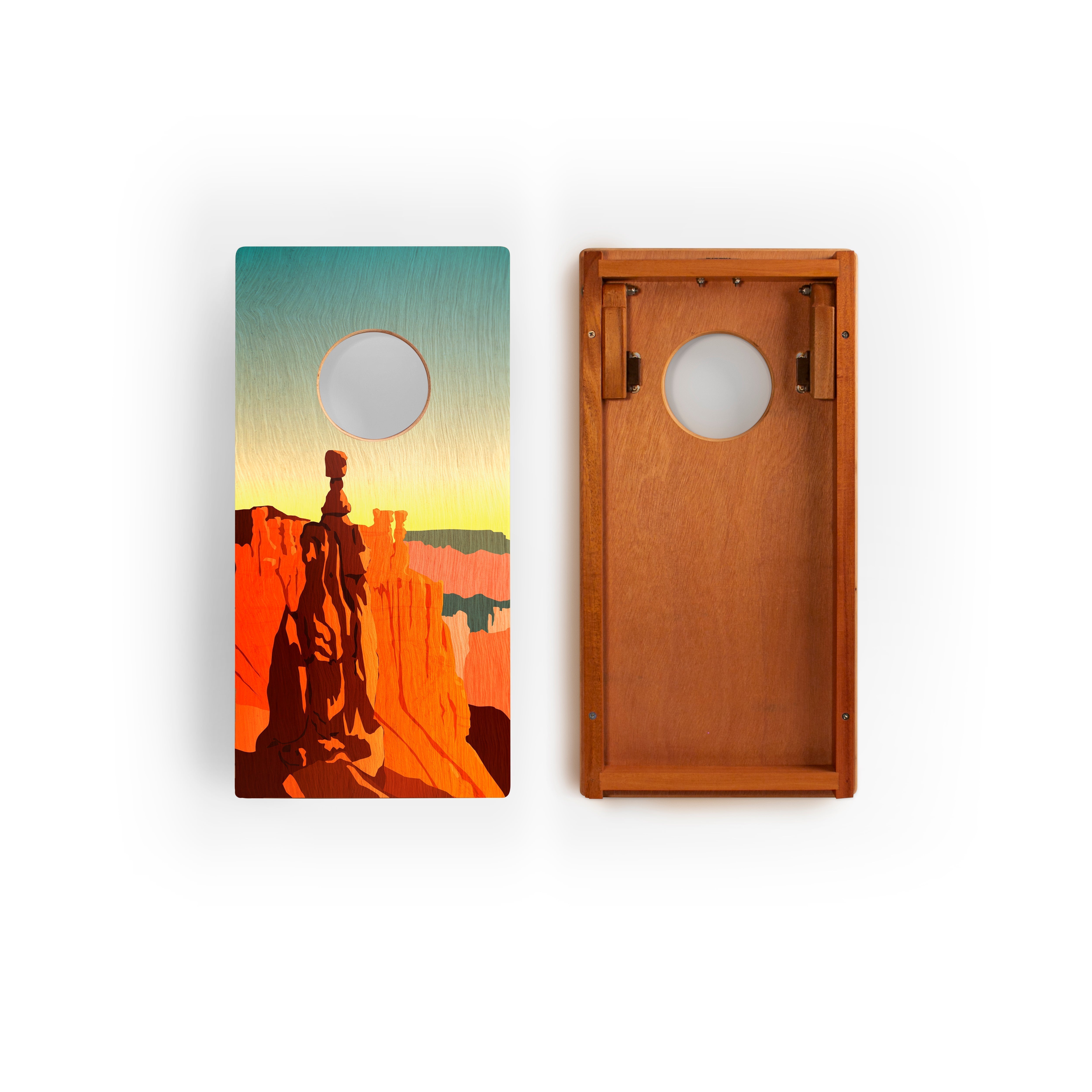 Two cornhole boards with a desert landscape design on a white background