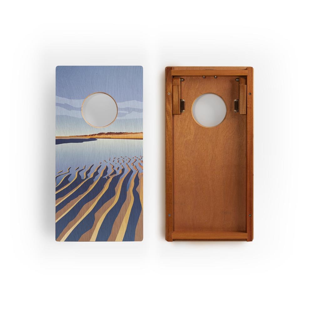 Two cornhole boards with beach scene design on a white background