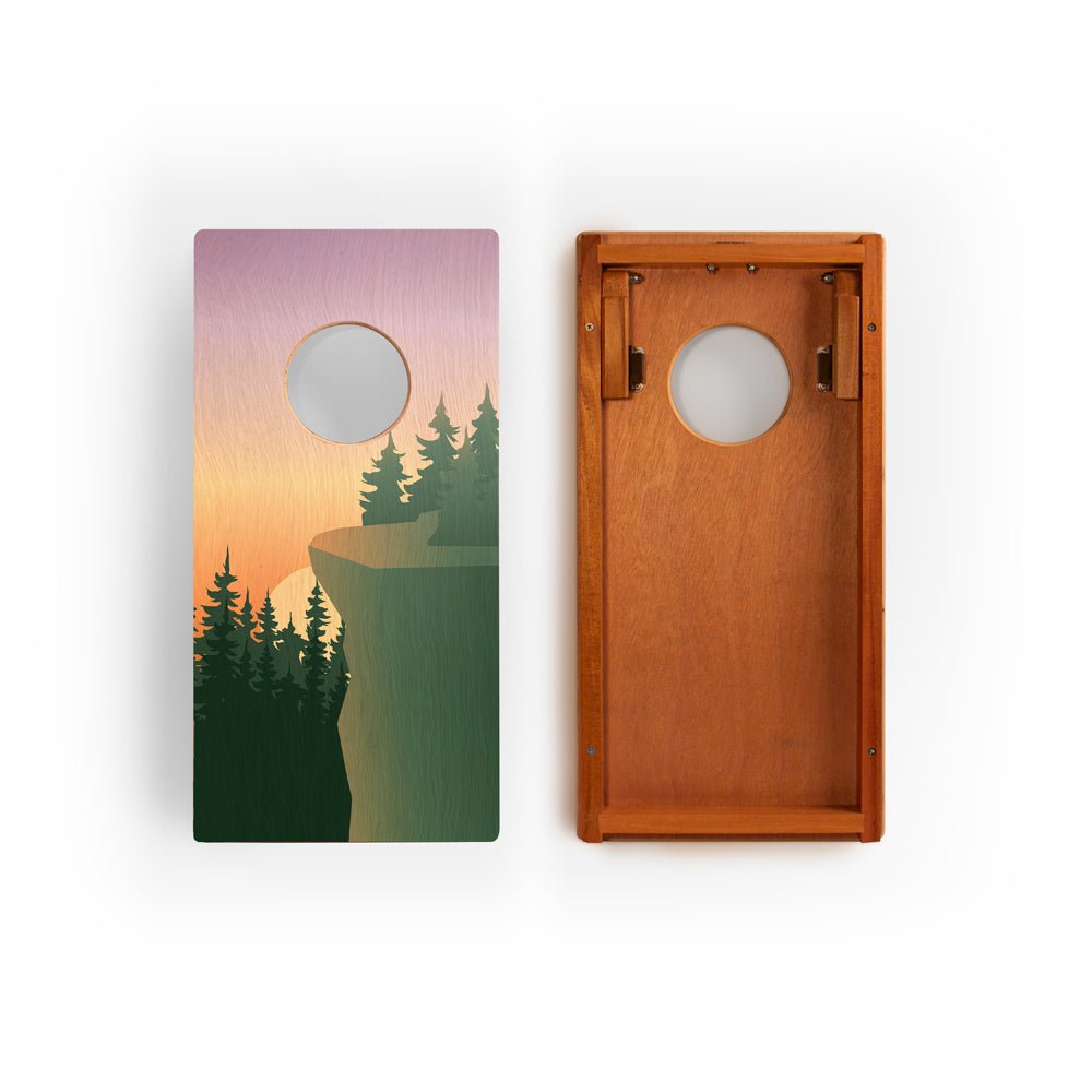 Two cornhole boards with nature-themed designs on a white background
