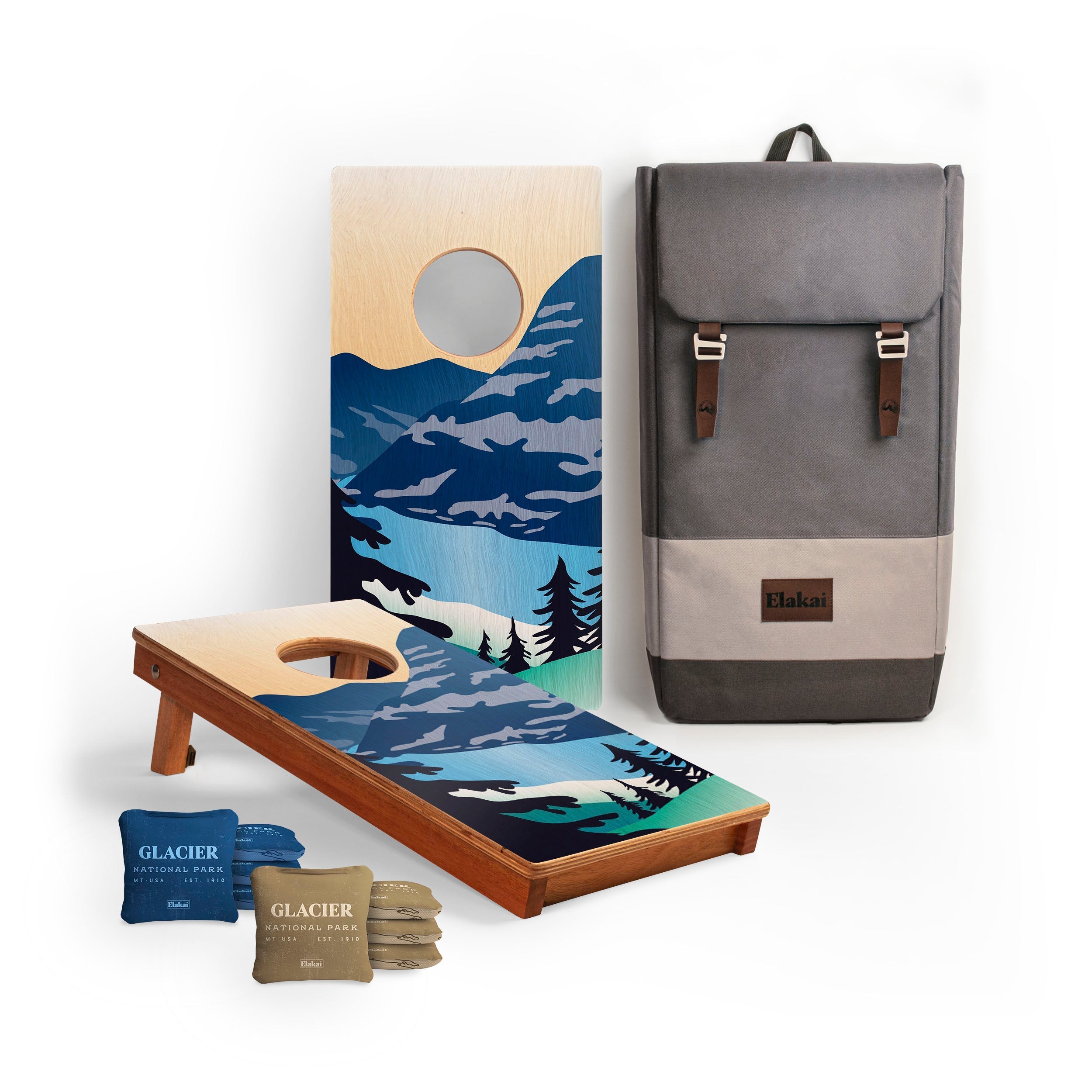 Cornhole boards with nature design, bean bags, and a backpack on a white background