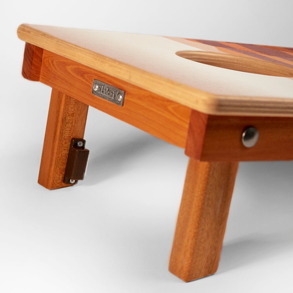 Wooden footstool with a visible brand label on a white background