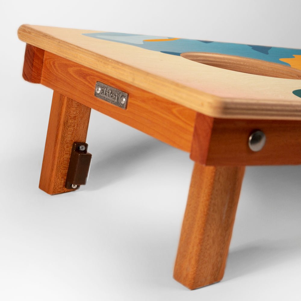 Wooden stool with a colorful top on a white background