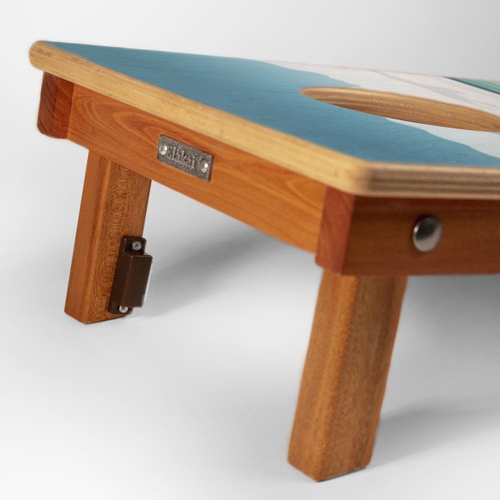 Wooden bench with a green cushion on a white background