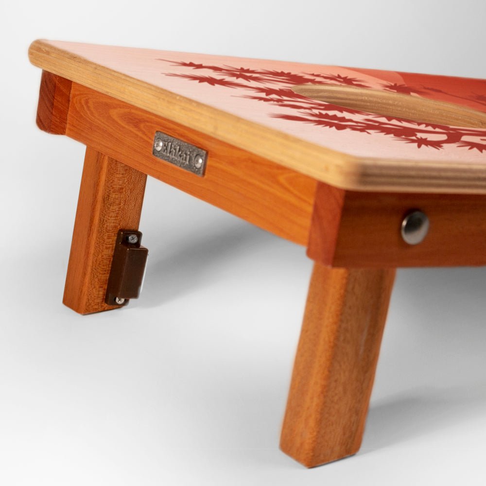 Wooden stool with a red floral pattern on a white background
