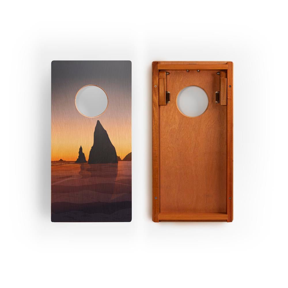 Wooden cornhole board with sunset beach scene design on a white background