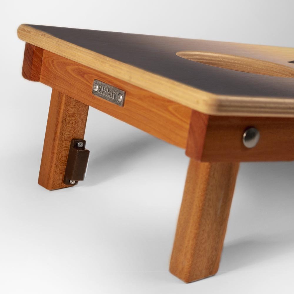 Wooden step stool with a black top on a white background