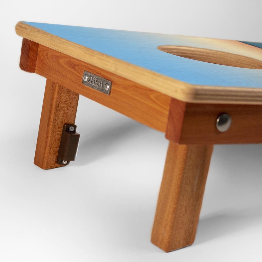 Wooden table with blue top and visible brand name on a white background