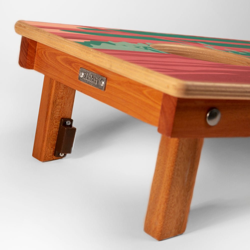 Wooden footstool with a colorful top on a white background