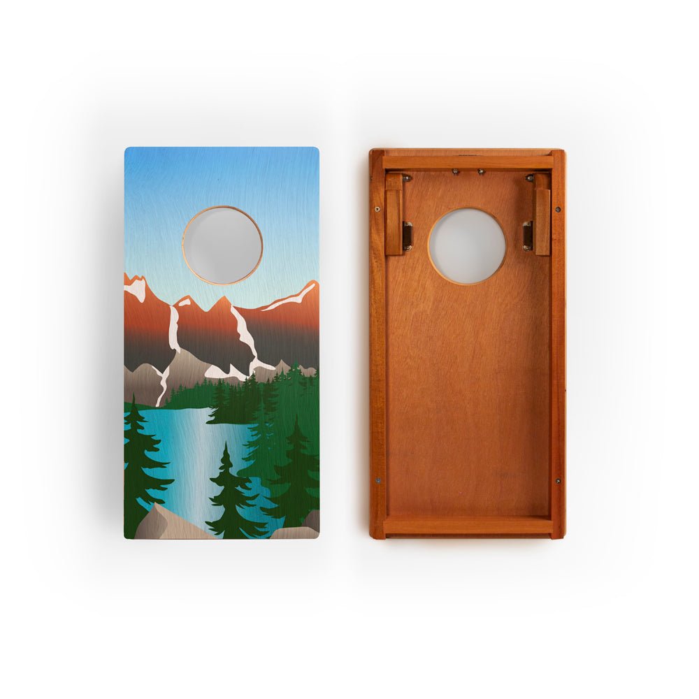 Two cornhole boards with nature-themed designs on a white background