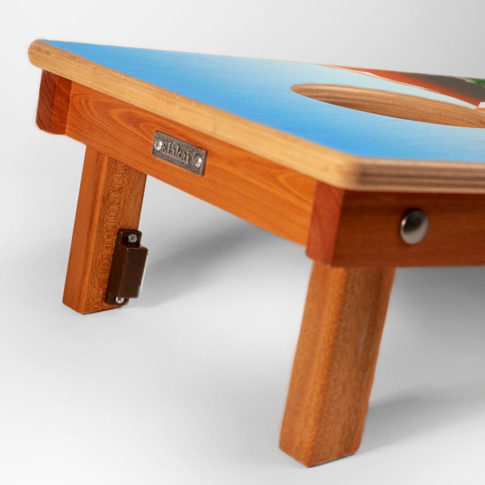 Wooden table with a blue top on a white background