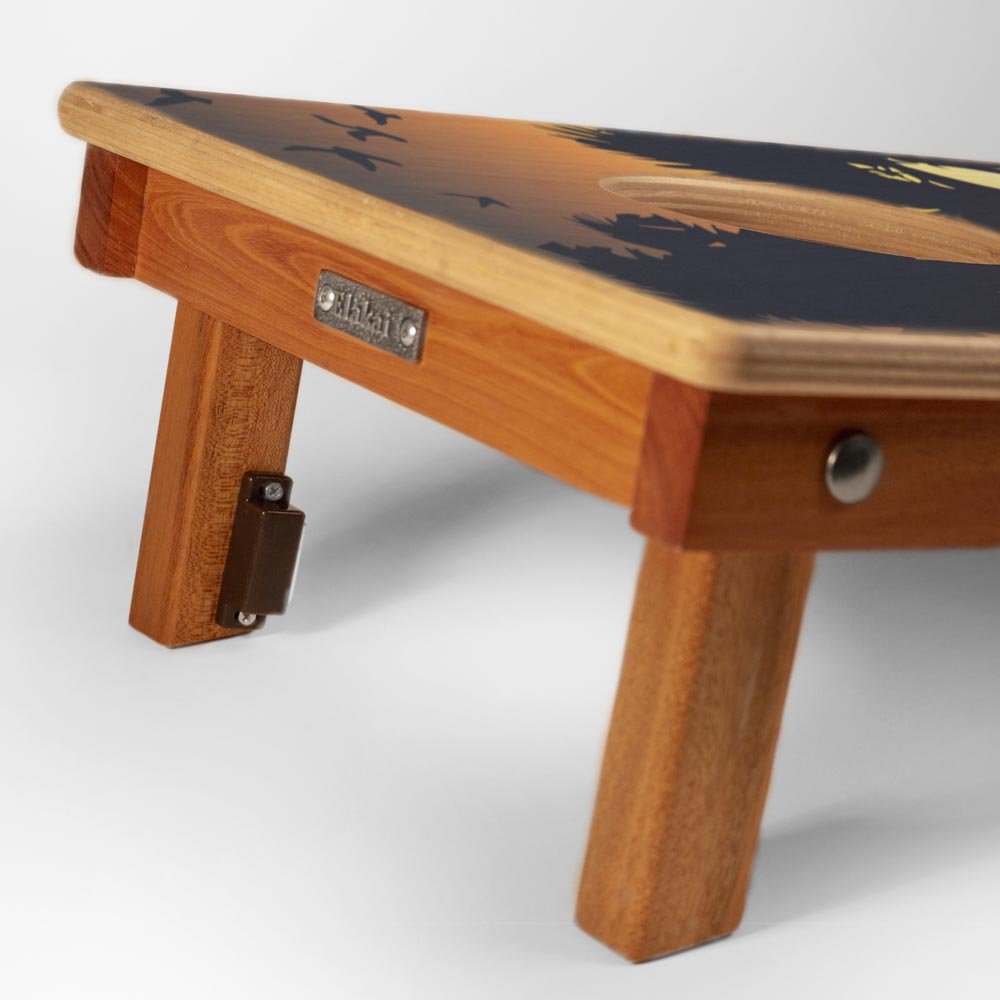 Wooden step stool with a black and gold design on a white background