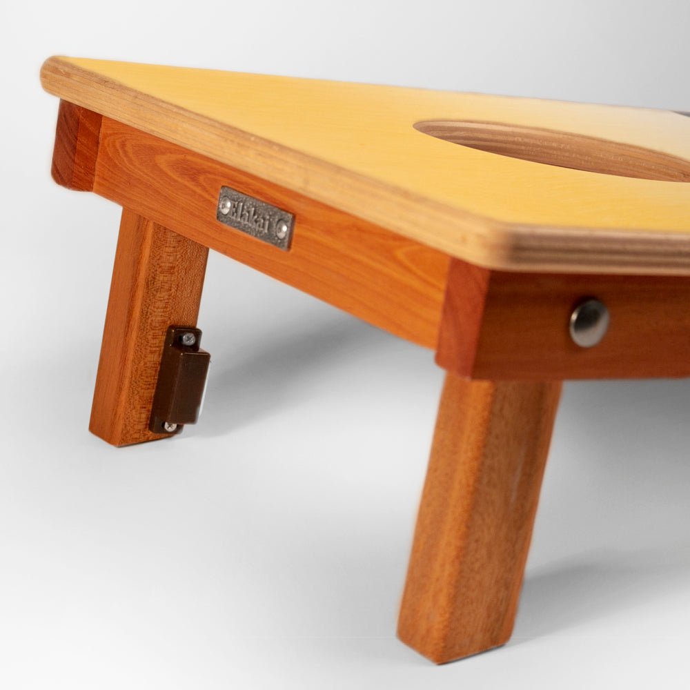 Wooden stool with a visible brand label on a white background