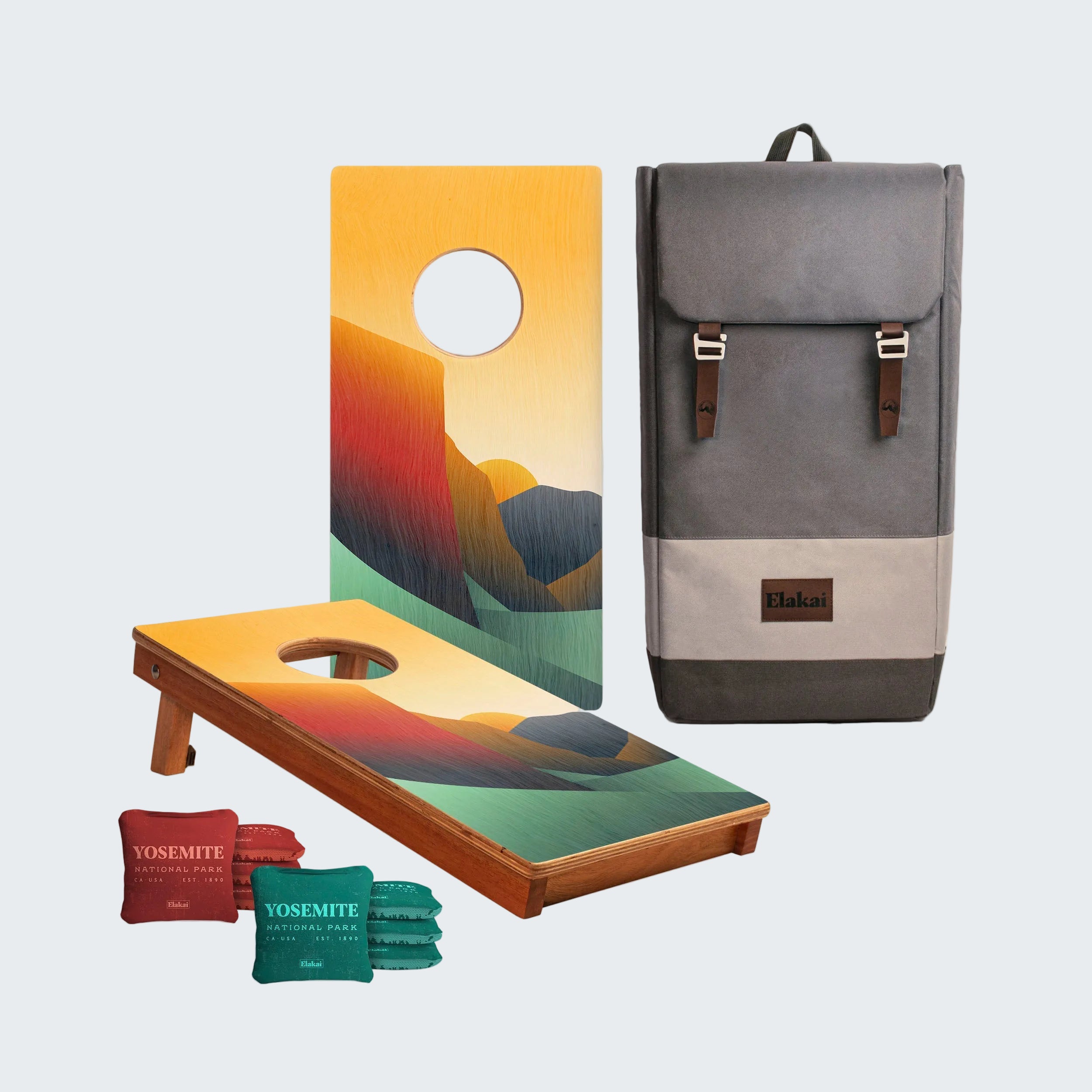 Cornhole boards with colorful design, backpack, and bags on a white background