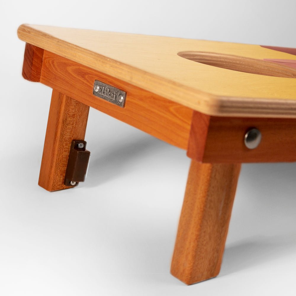Wooden stool with a visible brand label on a white background