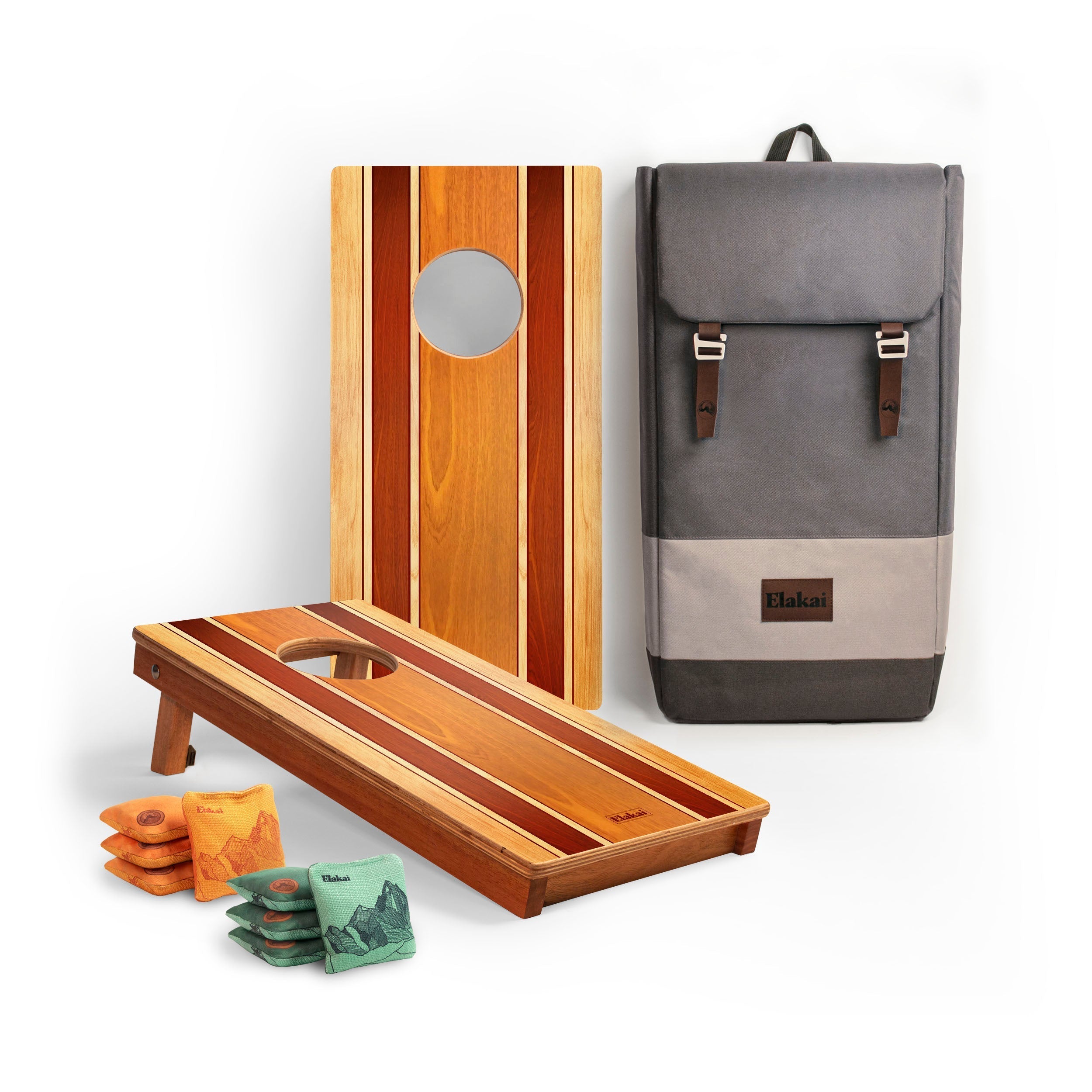 Cornhole board, bags, and a backpack on a white background
