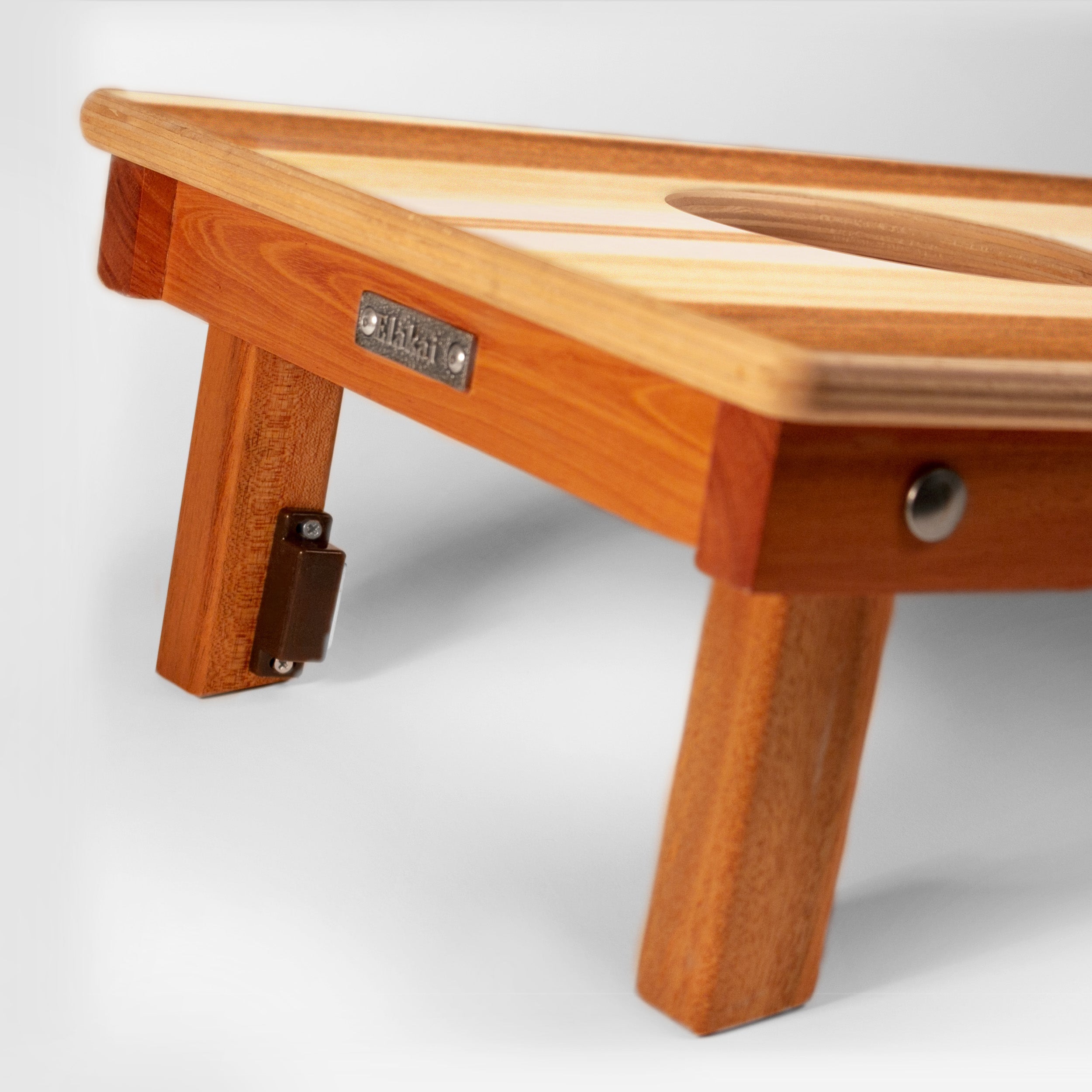 Wooden footstool with a visible brand label on a white background