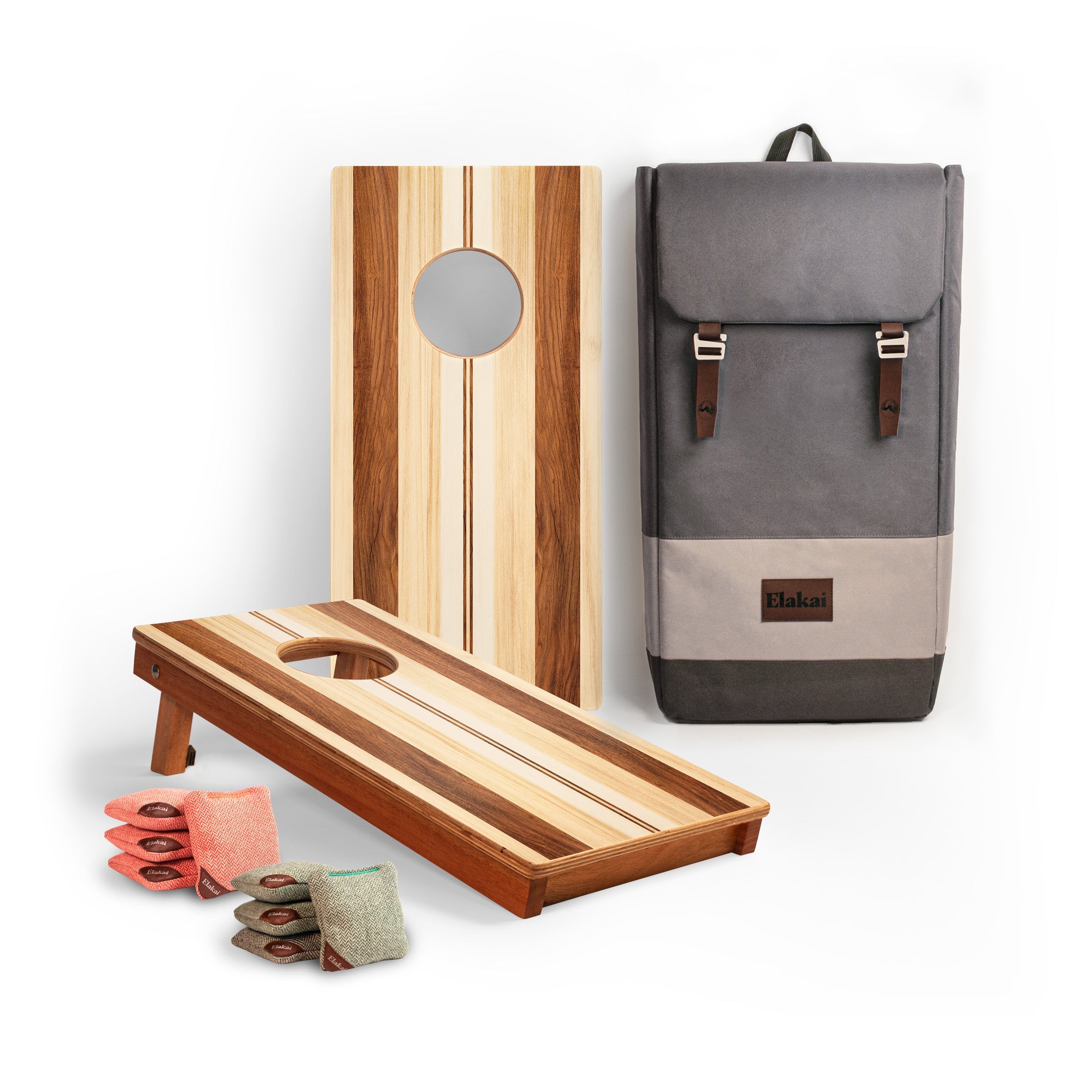 Wooden cornhole boards with bags and a gray backpack on a white background