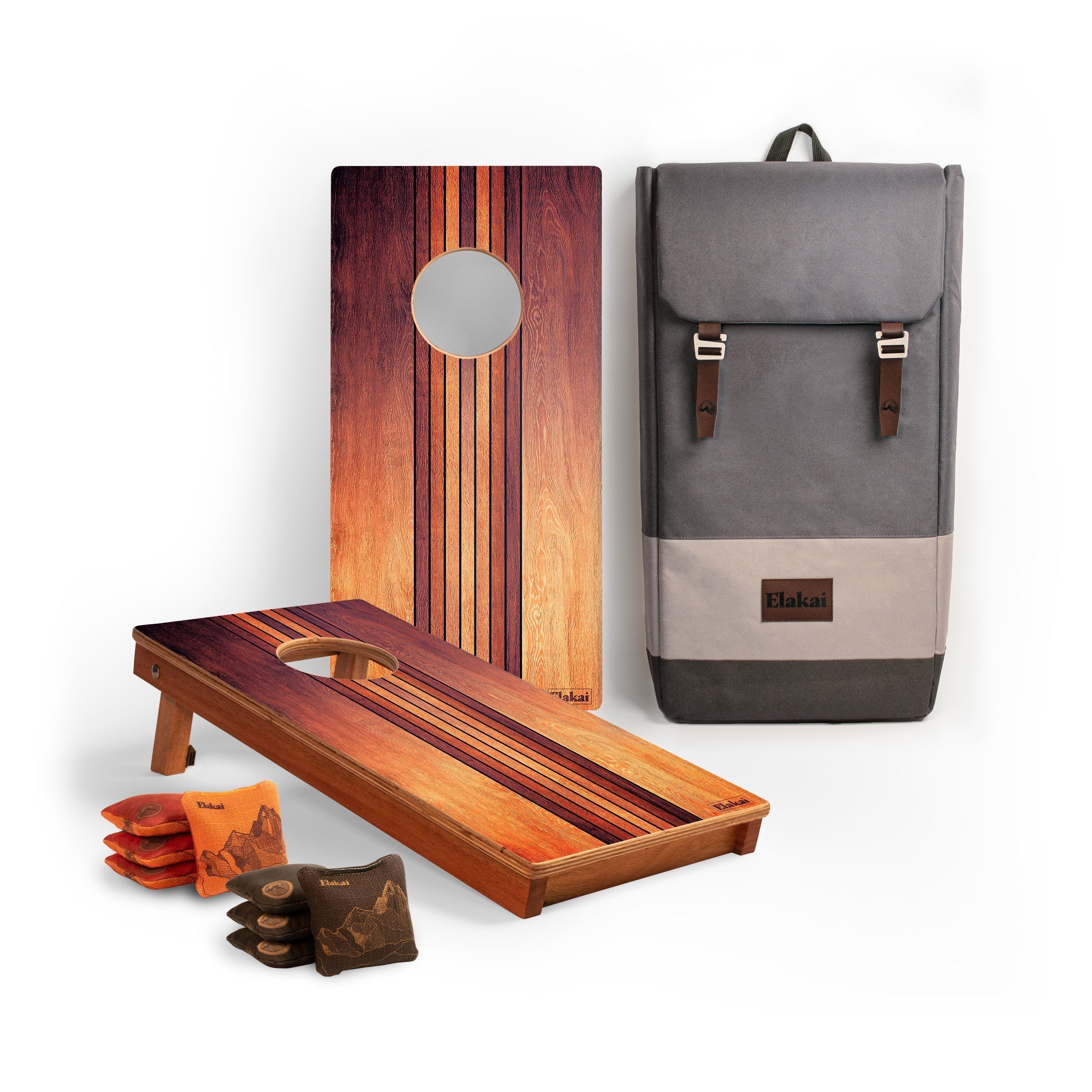 Wooden cornhole boards with bags and a gray backpack on a white background
