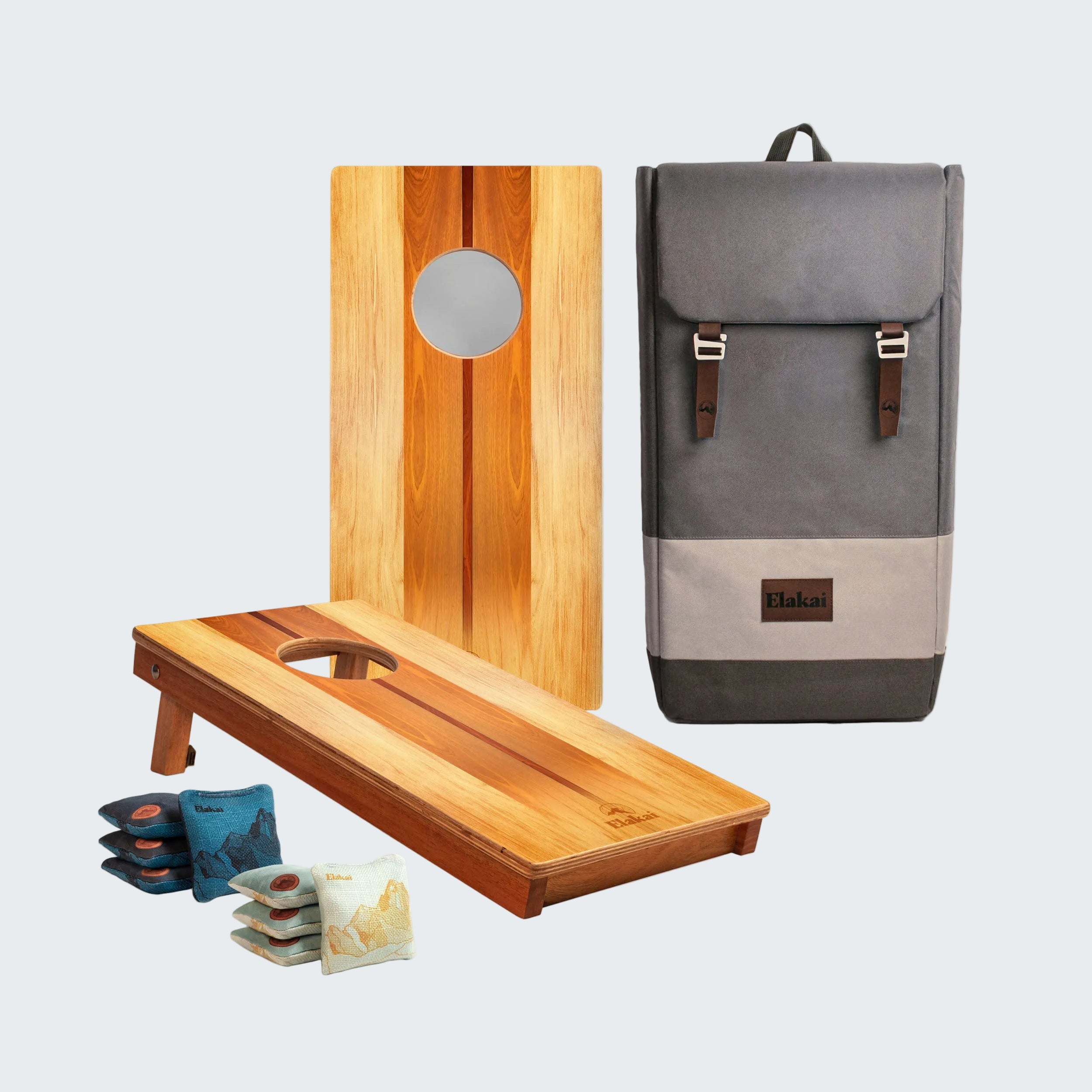 Cornhole boards and bags with a gray backpack on a white background