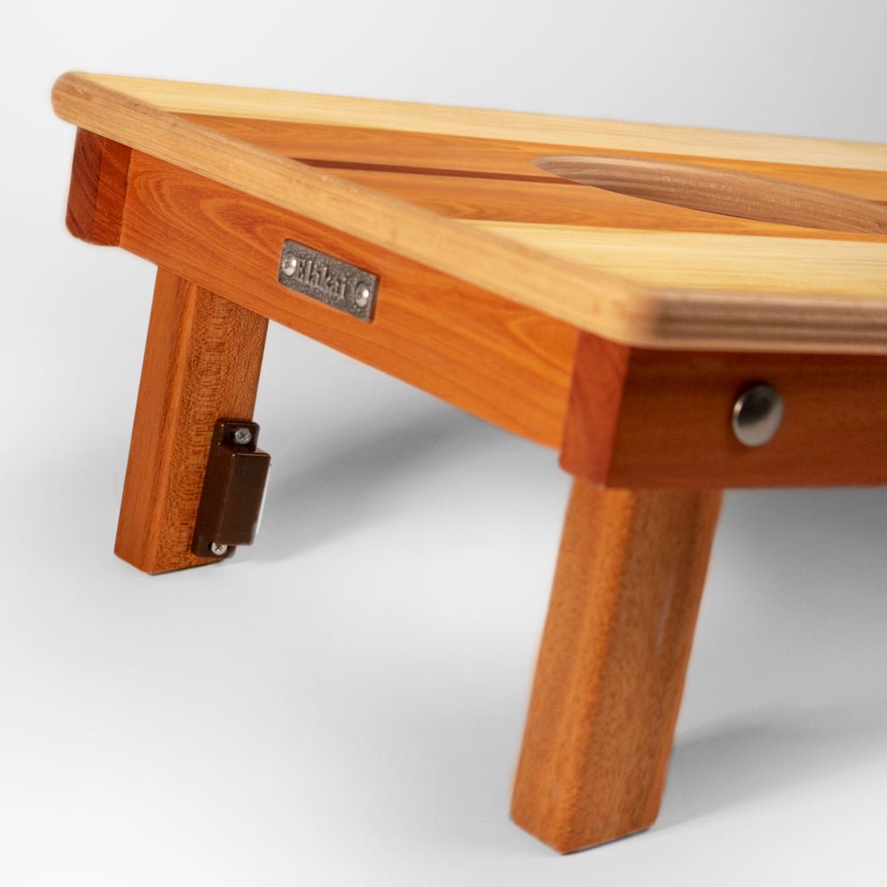 Wooden footstool with a visible brand label on a white background