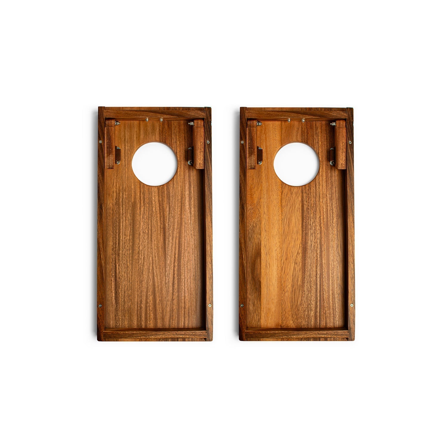 Two wooden cornhole boards with circular holes on a white background