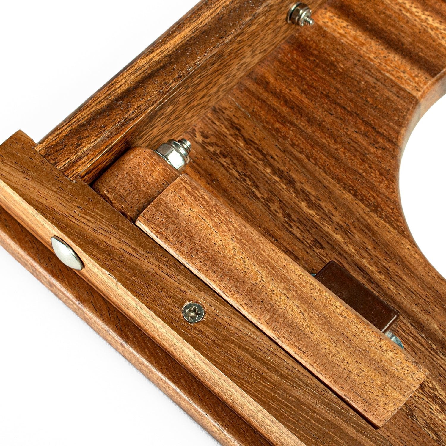Close-up of a wooden tool with metal components on a white background