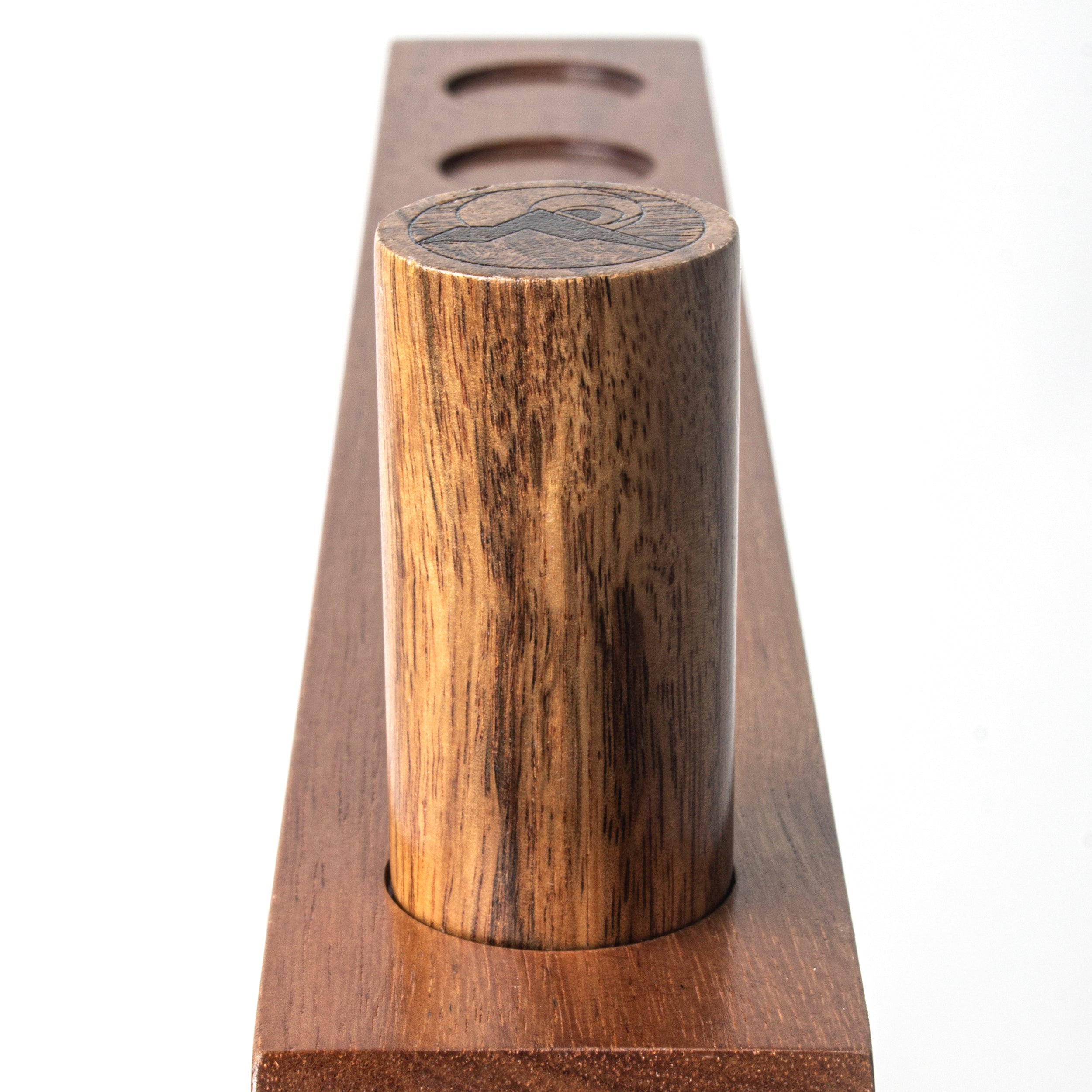 Wooden pepper grinder with a star design on a white background