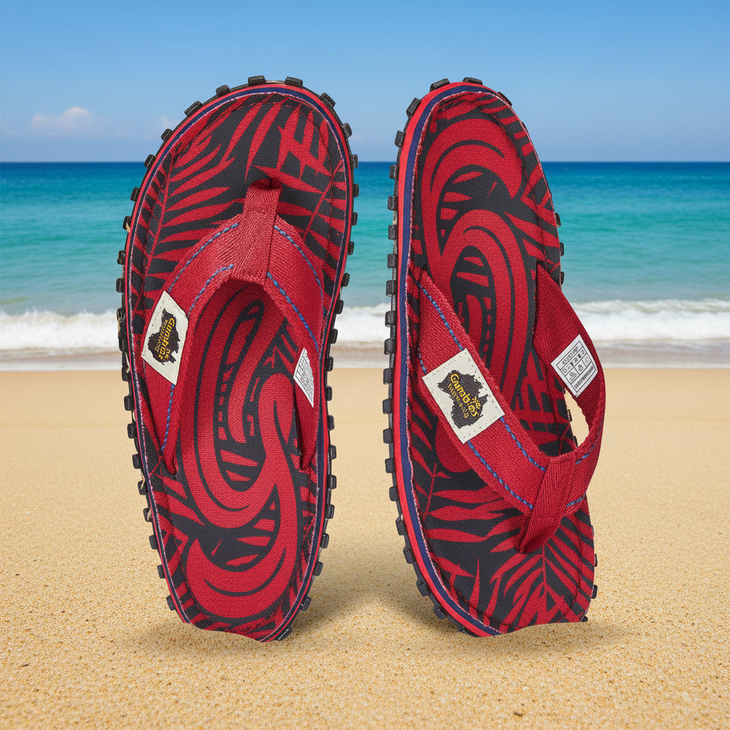 Red and black patterned flip-flops on a white background
