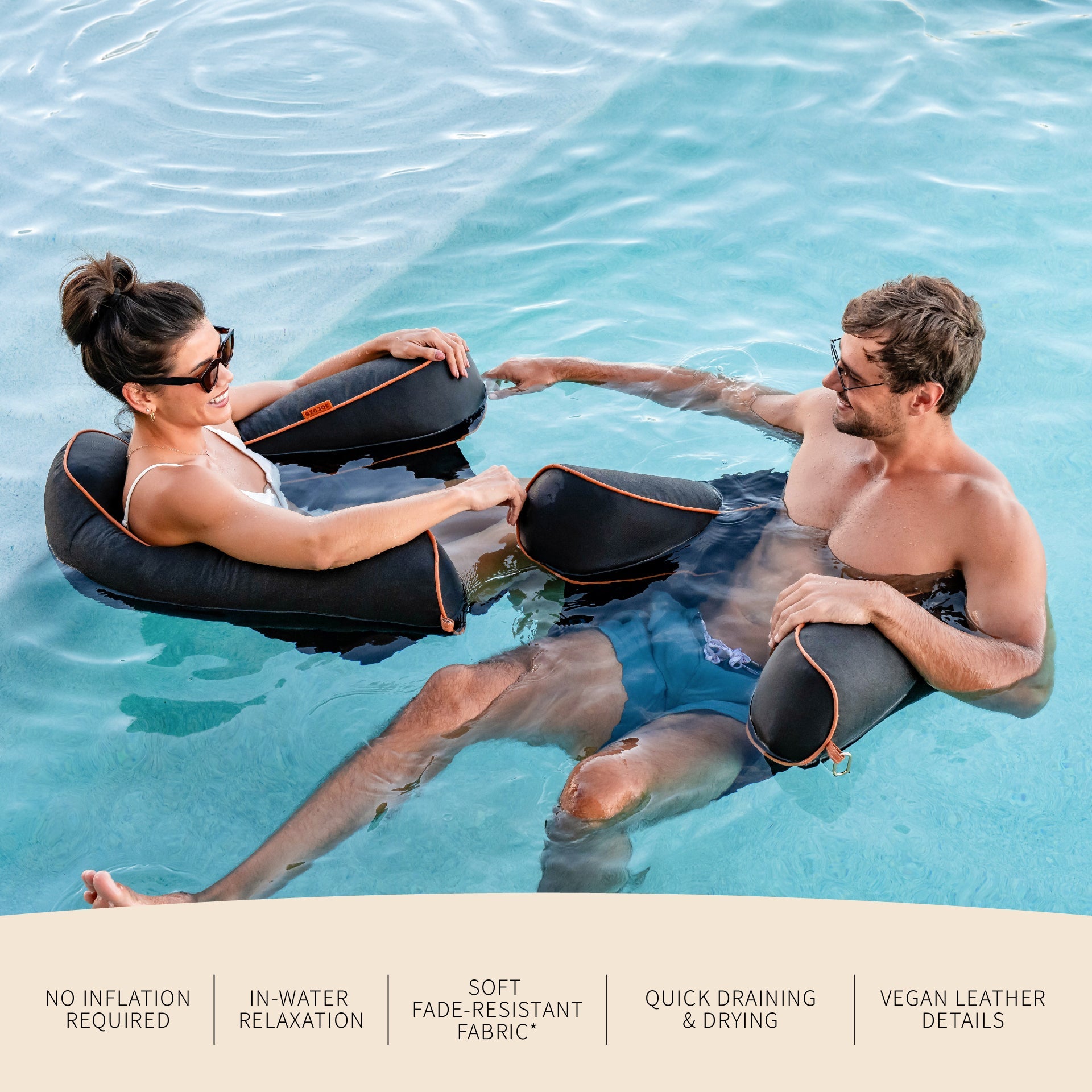 Two people relaxing in water with inflatable seats, surrounded by water.