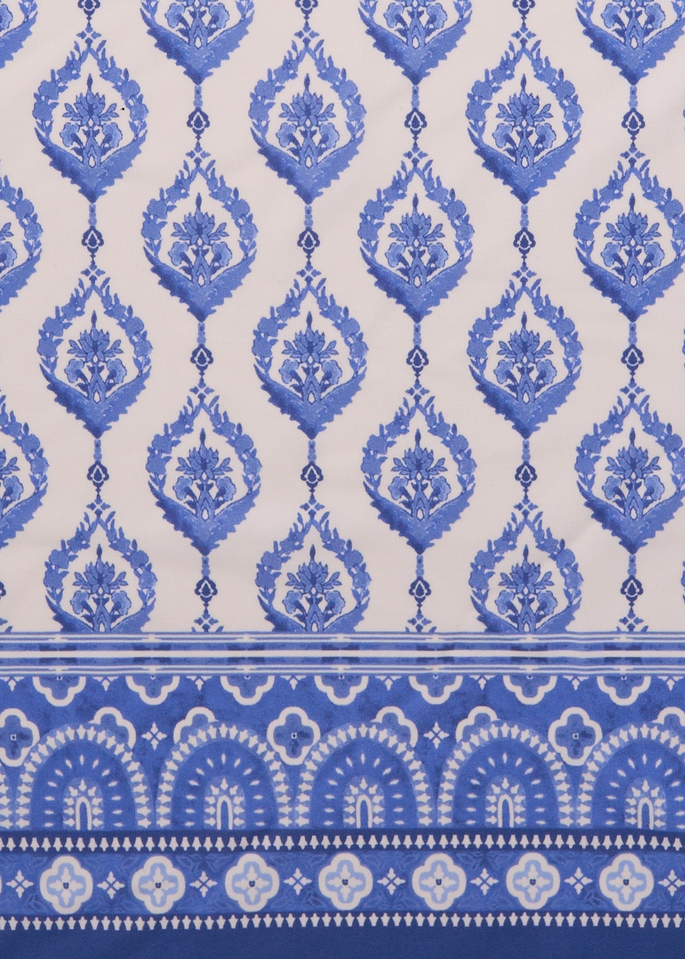 Patterned fabric with blue and white design on a blue background
