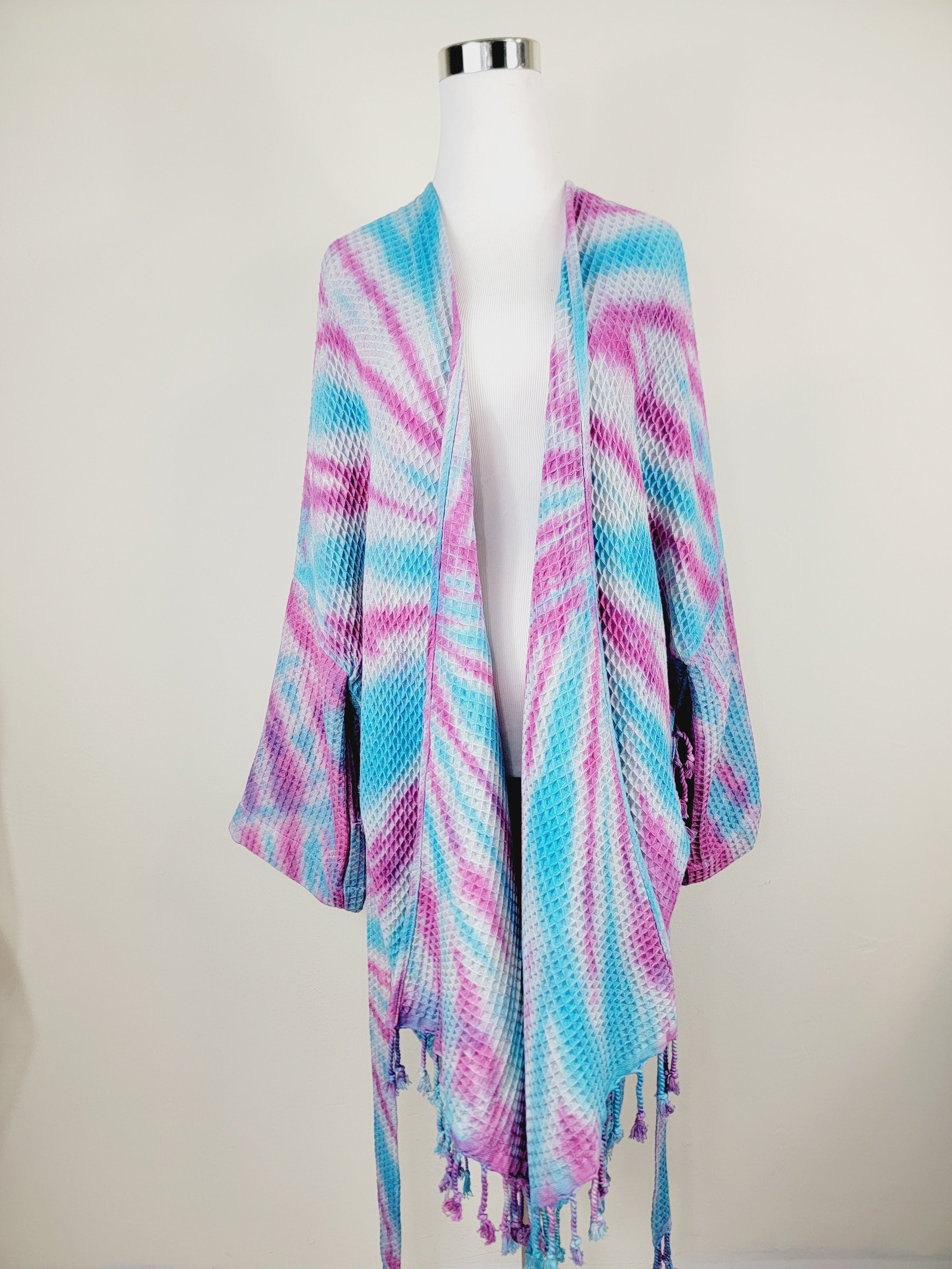 Colorful striped shawl on a mannequin against a white background