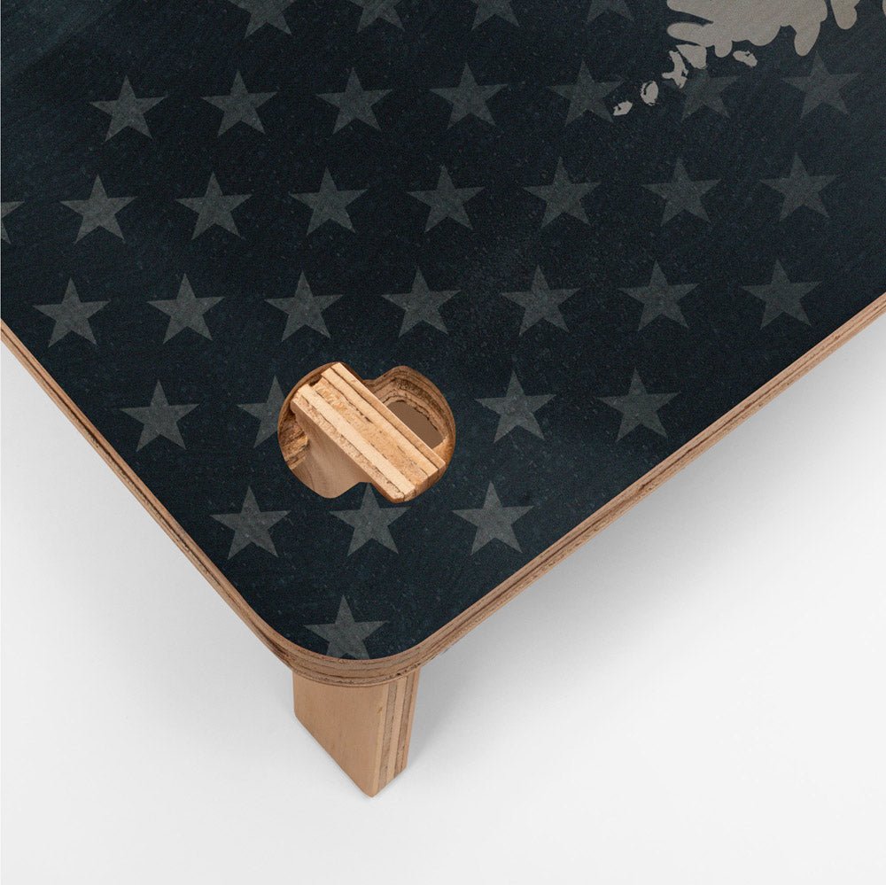 Black mat with star pattern and wooden holder on a white background