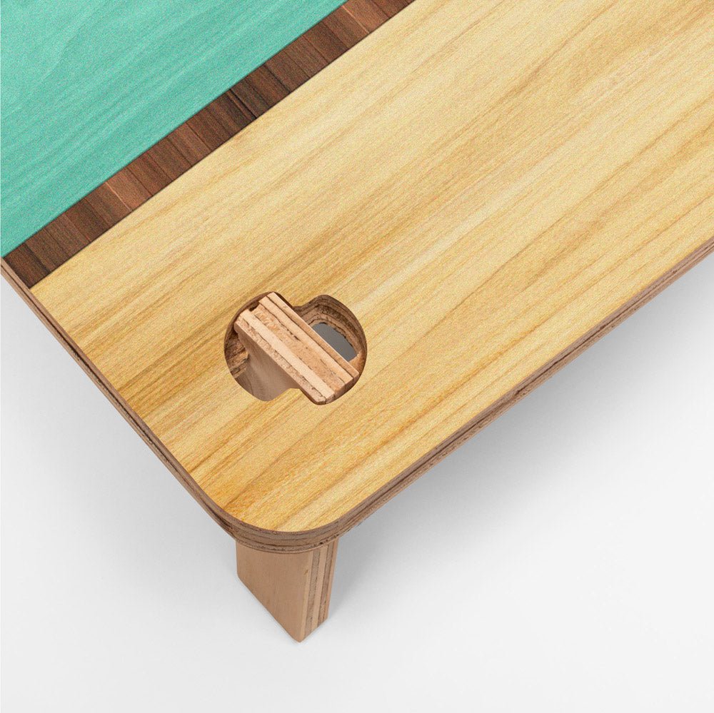 Wooden table corner with a geometric cutout on a white background