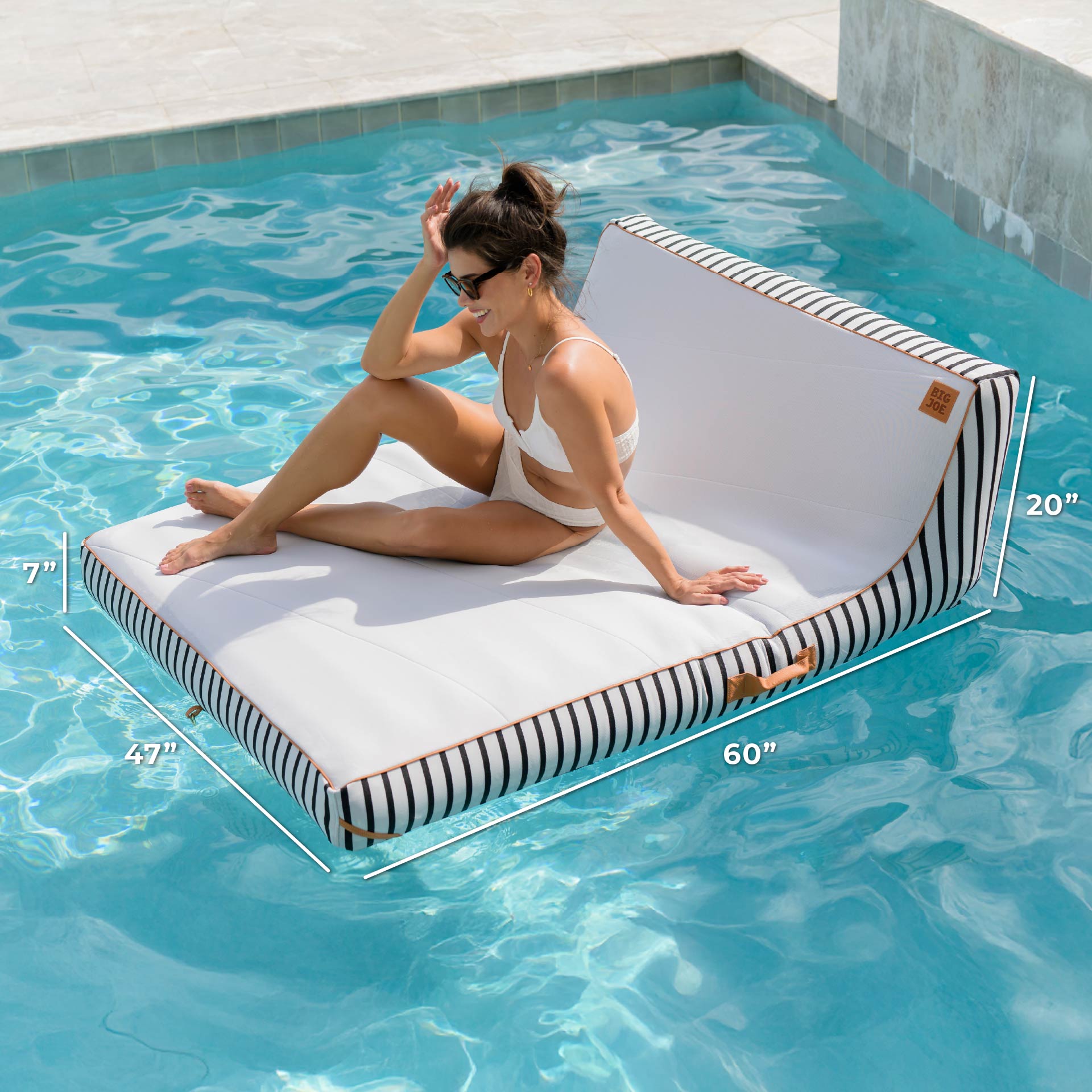 Woman sitting on a floating pool lounger with dimensions displayed, in a pool setting.