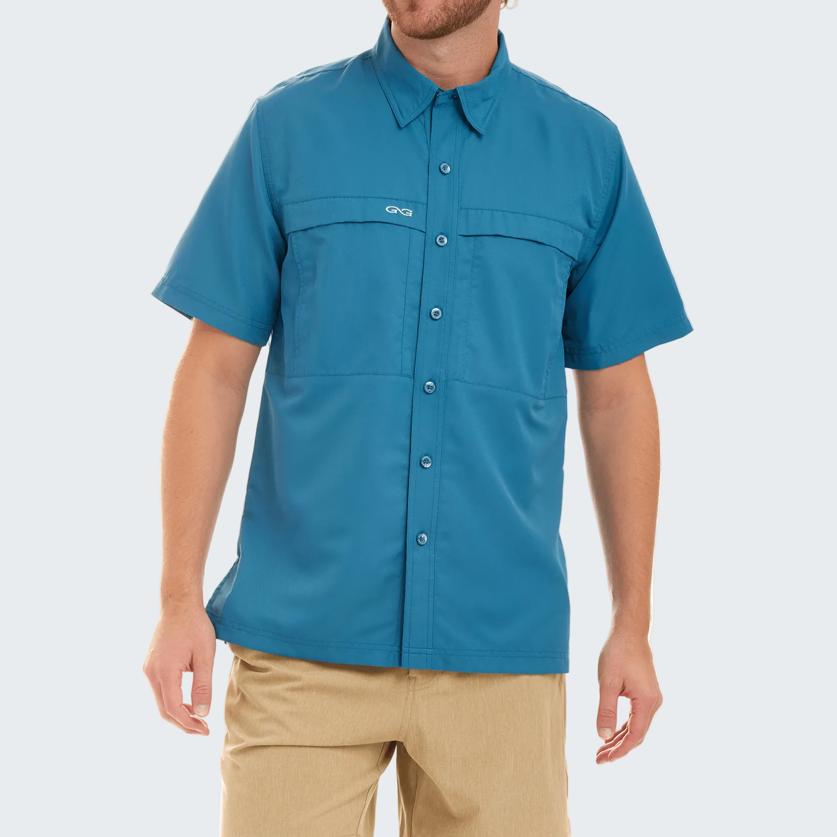 Man wearing a blue short-sleeve shirt with a brand logo on a white background