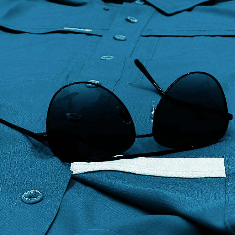 Black sunglasses on a blue shirt with a white collar