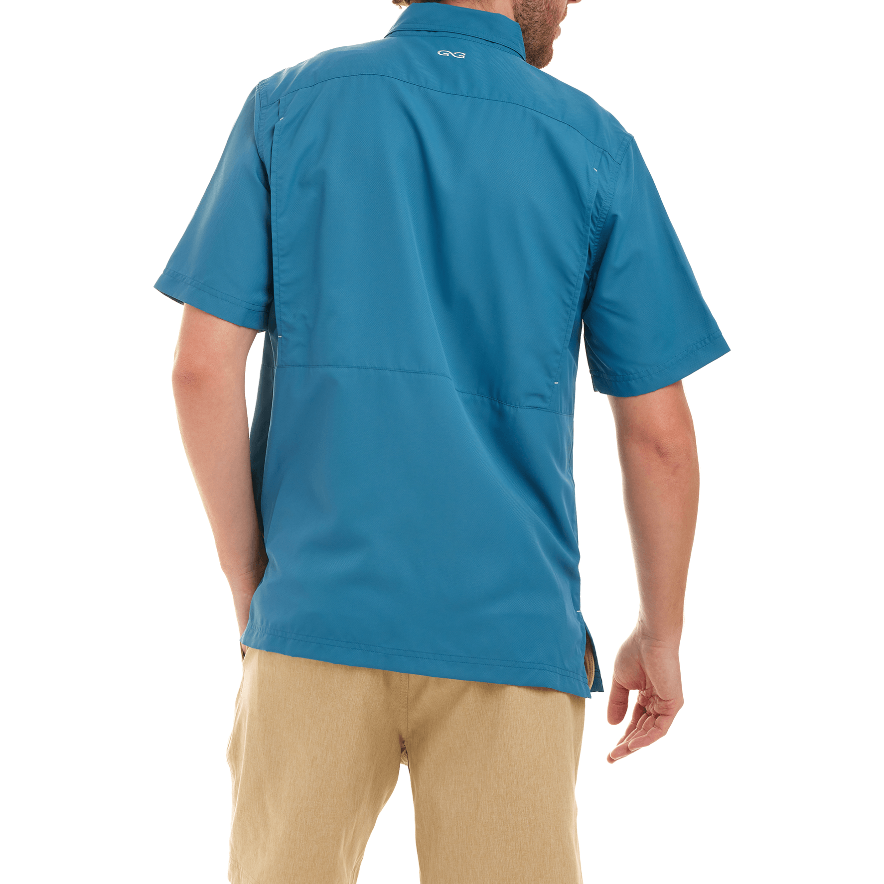 Person wearing a blue shirt with a visible brand logo on the back, standing against a white background.