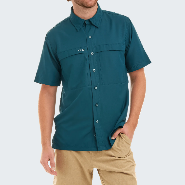 Man wearing a teal short-sleeve shirt with a brand logo on a white background
