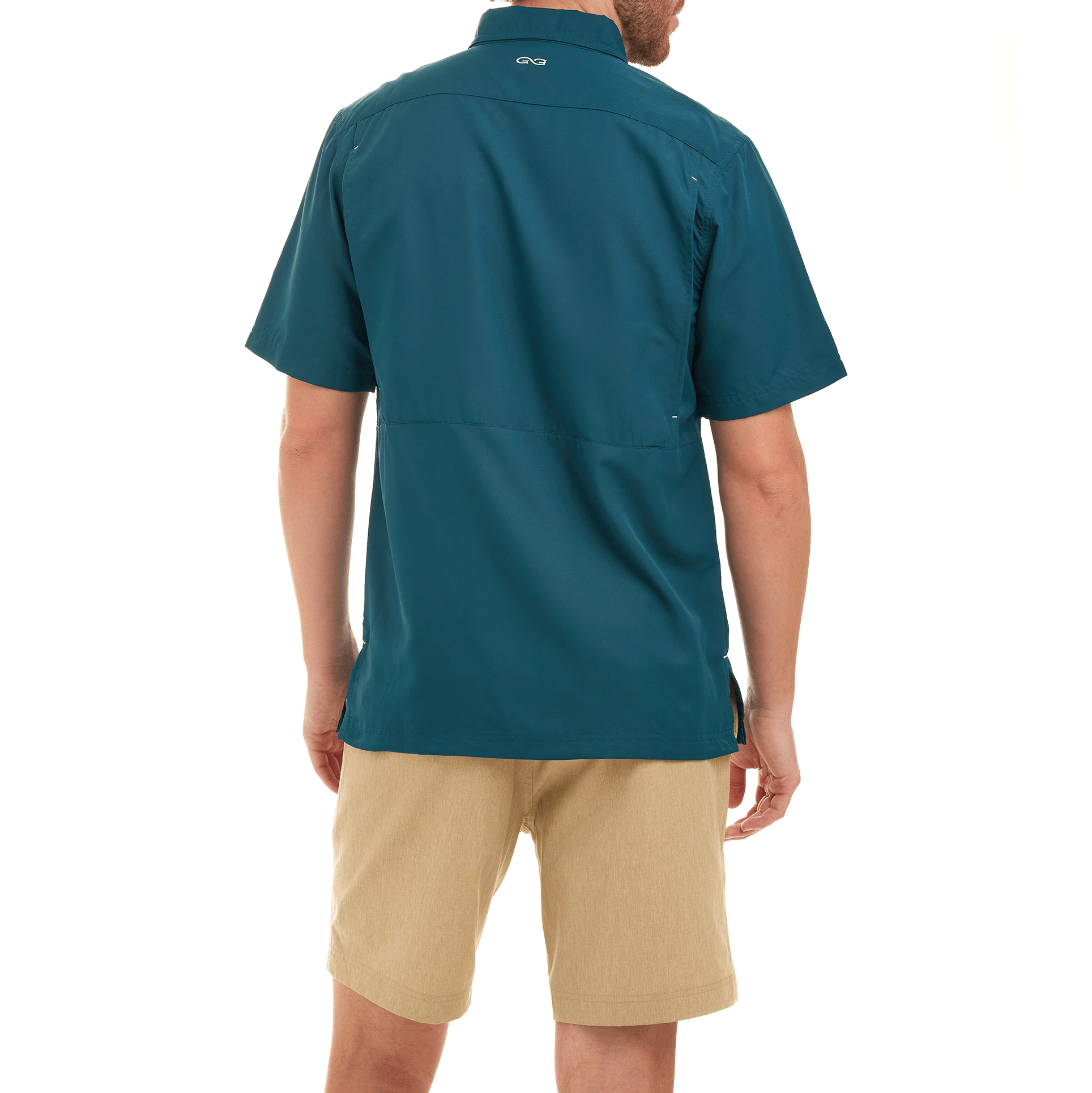Person wearing a teal shirt and beige shorts on a white background