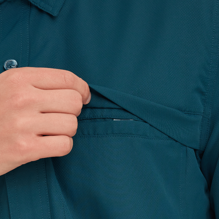 Close-up of a person adjusting the collar of a teal shirt.