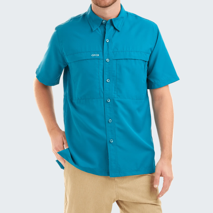 Man wearing a blue shirt with a brand logo on a white background