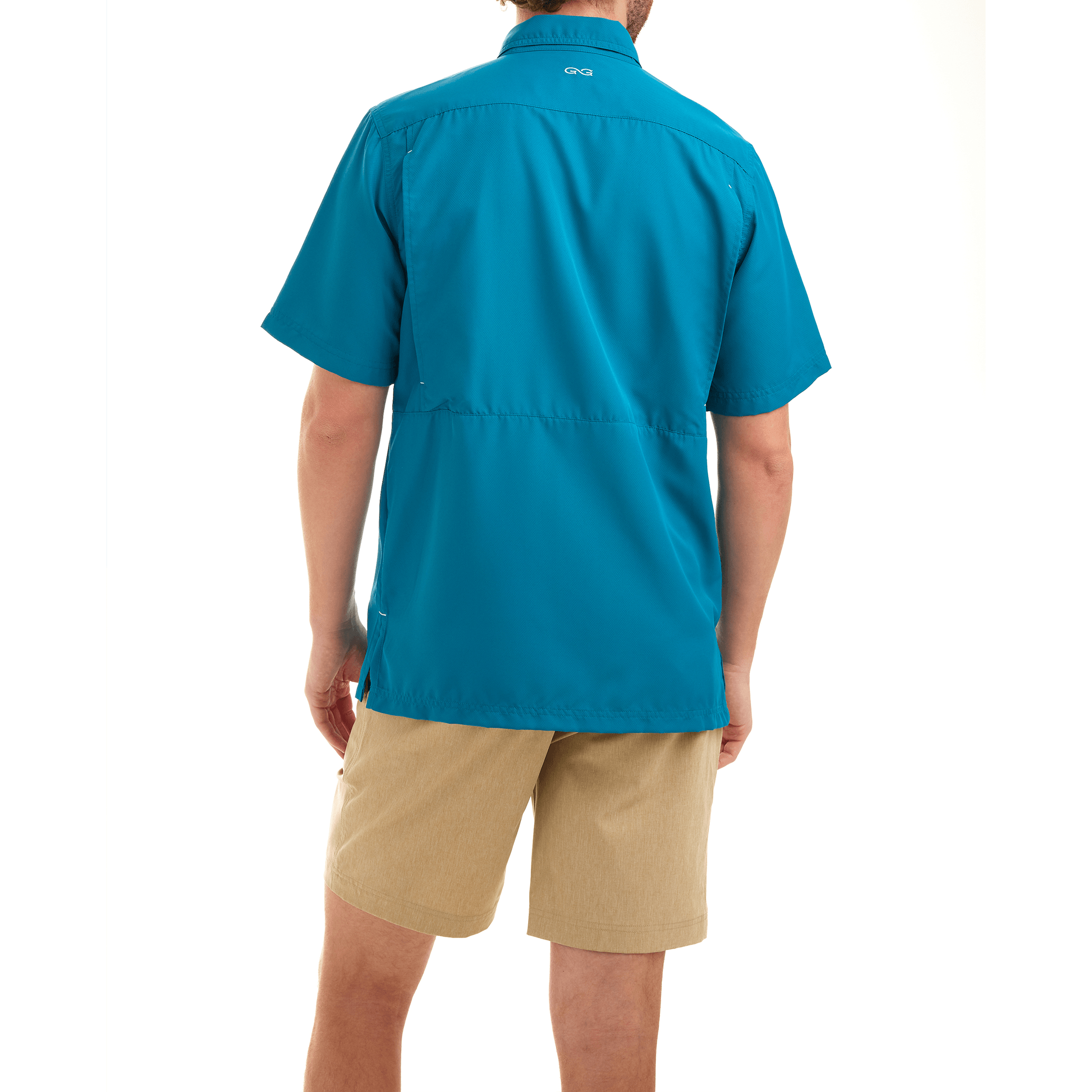 Person wearing a blue shirt and beige shorts on a white background