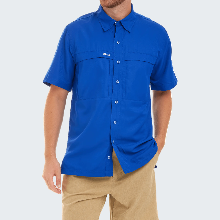 Man wearing a blue shirt with a brand logo on a white background